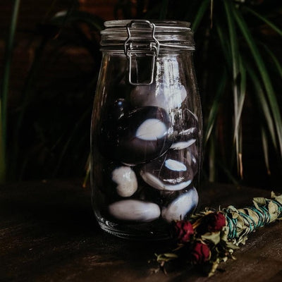 orca agate palmstones in glass jar